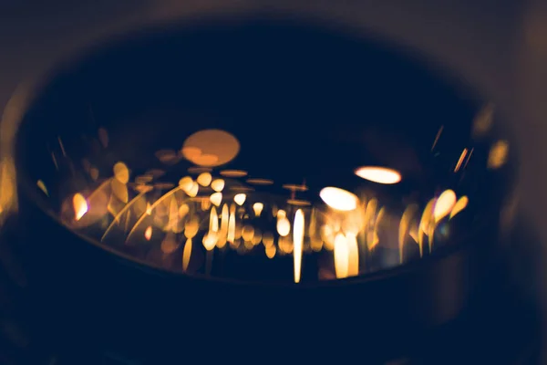 Close-up shot of garland lights reflecting in camera lens — Stock Photo