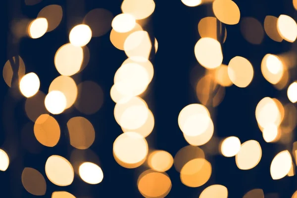 Beautiful round golden bokeh on black background — Stock Photo