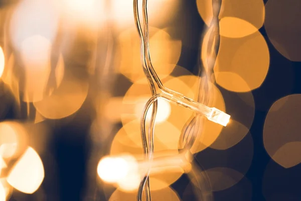 Close-up shot of beautiful christmas lights on dark background — Stock Photo