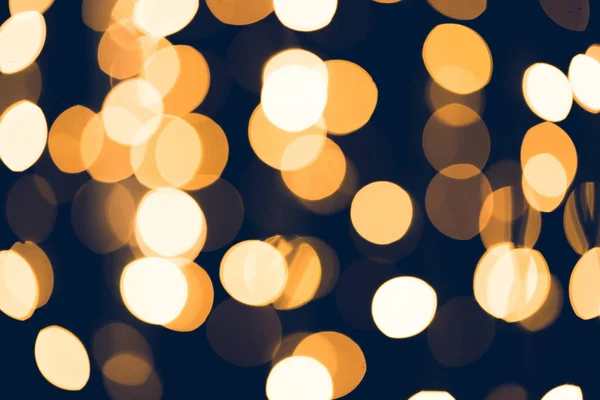 Golden round bokeh on black background — Stock Photo