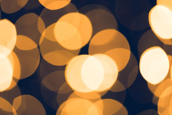 Abstraktes goldenes Bokeh auf schwarzem Hintergrund — Stockfoto