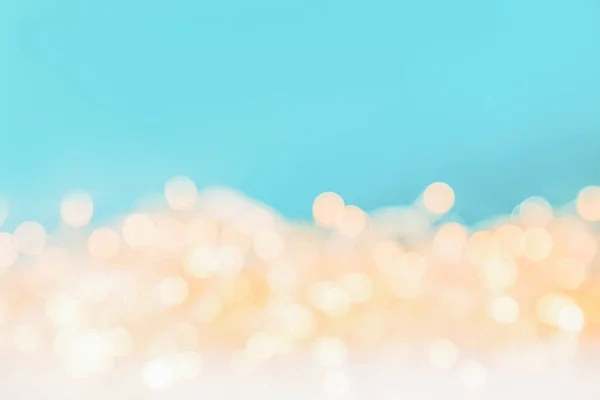 Shiny christmas bokeh lights on blue background — Stock Photo