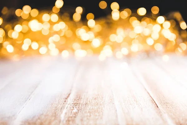 Festive bokeh lights on wooden surface, christmas decor — Stock Photo