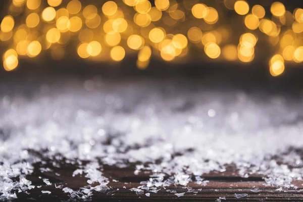 Christmas background with snow and shiny blurred lights — Stock Photo