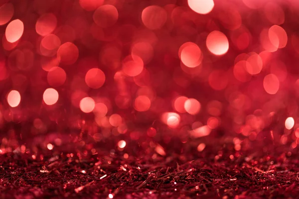 Christmas background with red bright blurred confetti — Stock Photo