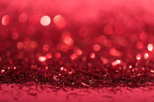 Christmas background with red shiny blurred confetti — Stock Photo