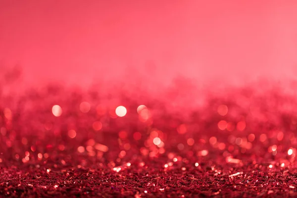 Christmas background with red shiny confetti with bokeh — Stock Photo