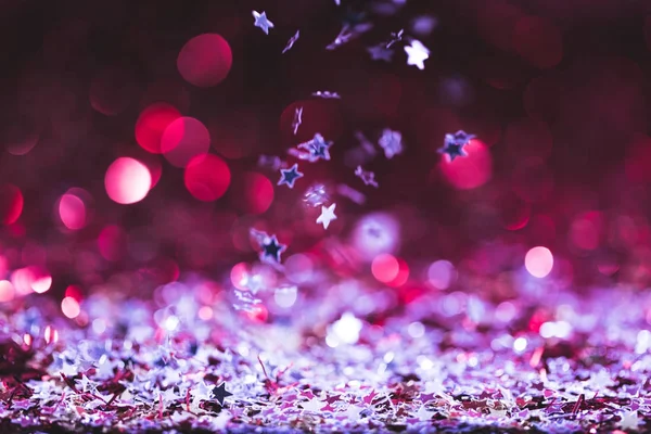 Christmas texture with falling pink and silver shiny confetti stars — Stock Photo