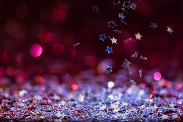 Christmas background with falling pink and silver shiny confetti stars — Stock Photo