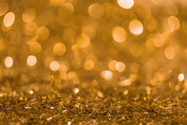 Christmas texture with golden shiny blurred confetti — Stock Photo