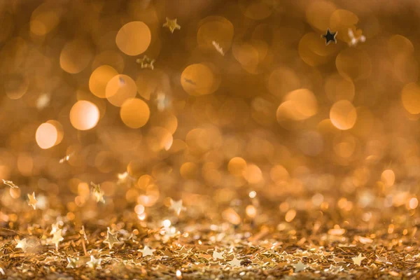 Christmas background with falling golden shiny confetti stars — Stock Photo