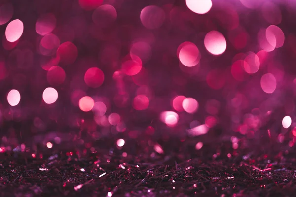 Christmas background with pink and purple shiny confetti — Stock Photo