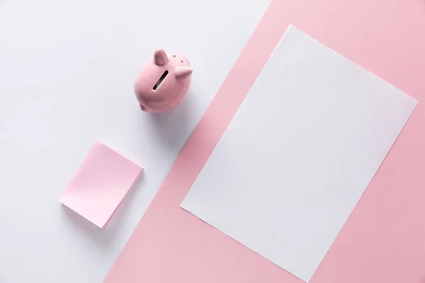 Top view of pink piggy bank, empty sticky notes and paper — Stock Photo