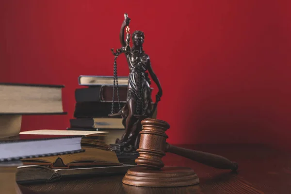 Opened juridical books with lady justice statue and gavel on wooden table, law concept — Stock Photo