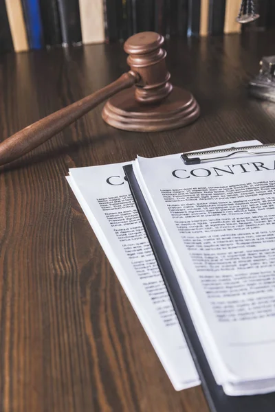 Juridical contract on wooden table with hammer , law concept — Stock Photo