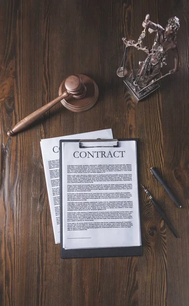 Top view of wooden table with document, hammer and statue of lady justice, law concept — Stock Photo