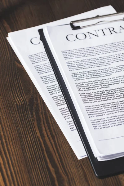 Juridical contract documents on wooden table, law concept — Stock Photo