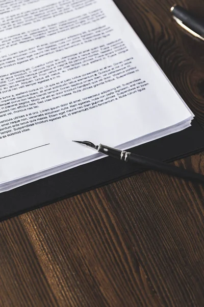 Juridical contract on wooden table with pen, law concept — Stock Photo