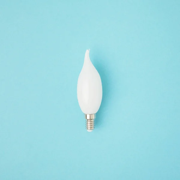 Крупным планом вид белой лампочки, изолированной на синем — стоковое фото