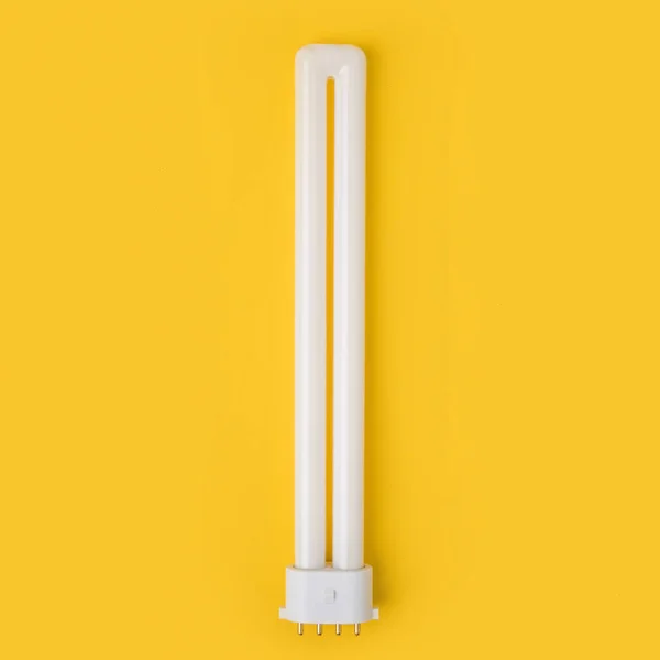 Close up view of white light bulb isolated on yellow — Stock Photo