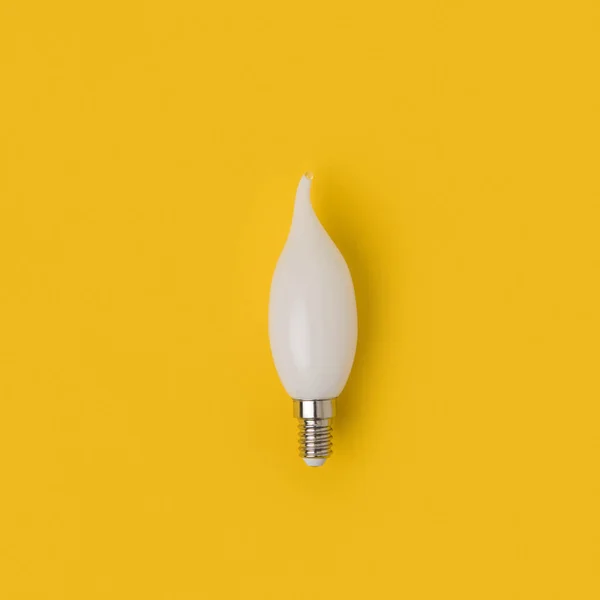 Close up view of white light bulb isolated on yellow — Stock Photo