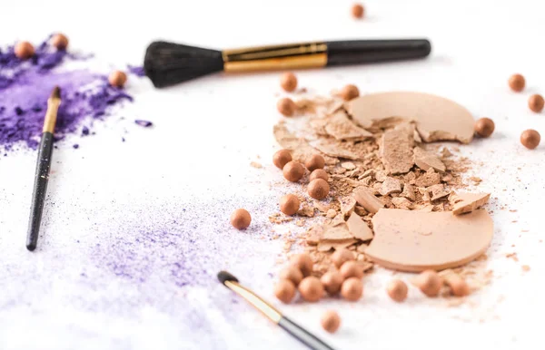 Various cosmetic powder with brushes on white tabletop — Stock Photo