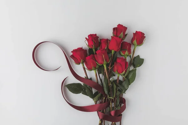 Top view of beautiful red roses with ribbon isolated on white, st valentines day concept — Stock Photo