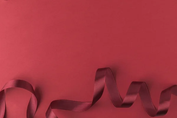 Top view of ribbon for decorating presents isolated on red — Stock Photo