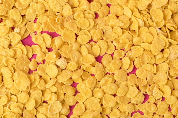 Top view of delicious tasty crispy corn flakes on pink — Stock Photo