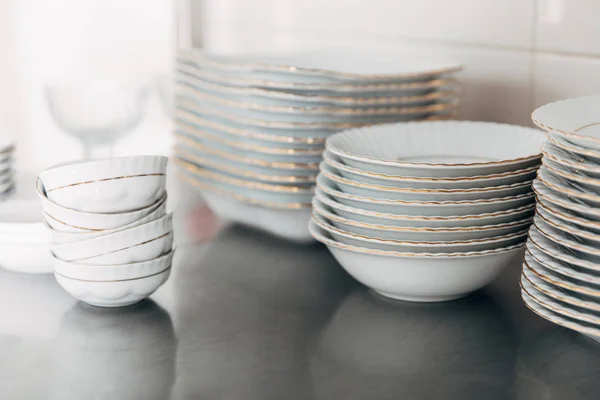 Close-up shot of various stacked clean tableware at restaurant — Stock Photo