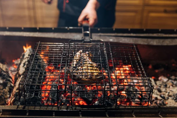 Cropped shot of chef grilling steak on flame — Stock Photo