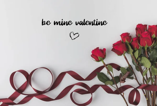 Top view of beautiful red roses with ribbon isolated on white, st valentines day concept — Stock Photo