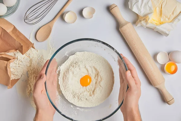 Cropped image of chef holding glass bowl with flour and egg — Stock Photo