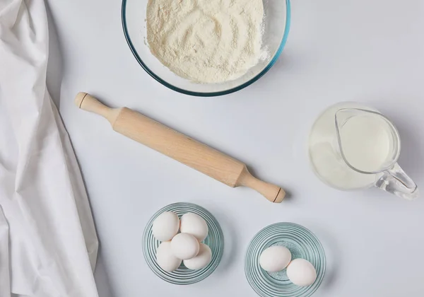 Top view of ingredients for dough and tablecloth on tabletop — Stock Photo