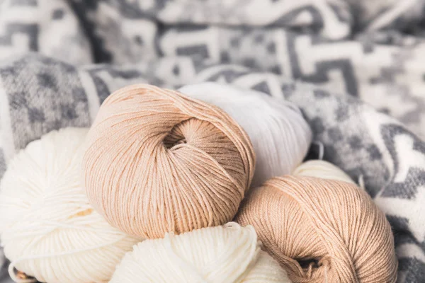 Colored yarn balls and blanket on background — Stock Photo