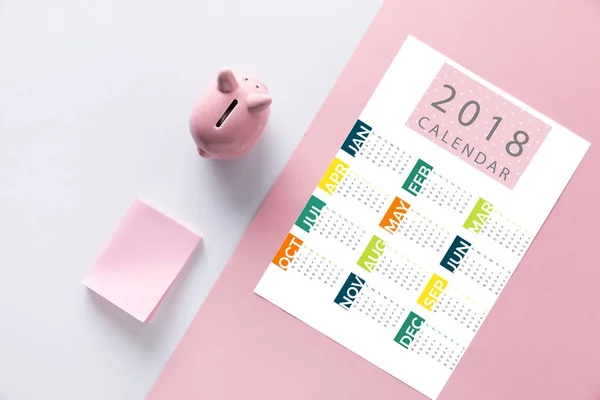 Top view of arranged piggy bank, empty notes and 2018 calendar — Stock Photo