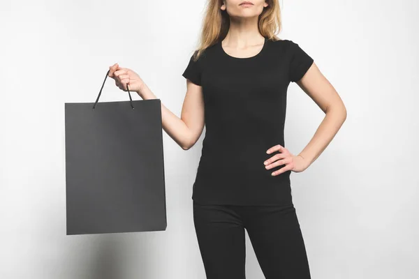 Cropped shot of young woman in blank black t-shirt on white — Stock Photo