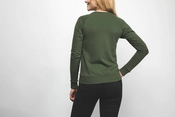 Rear view of young woman in blank green sweatshirt on white — Stock Photo