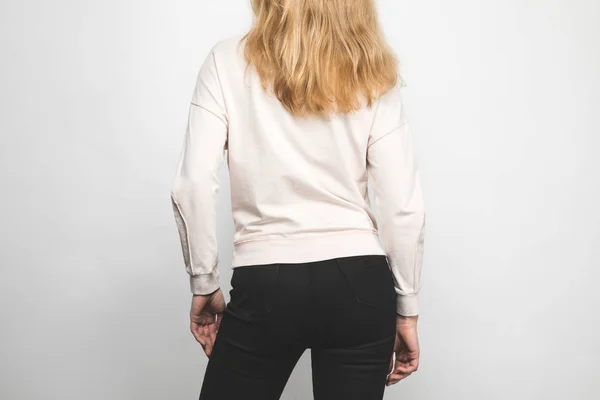 Rear view of young woman in blank sweatshirt on white — Stock Photo