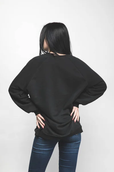 Back view of young woman in blank sweatshirt on white — Stock Photo