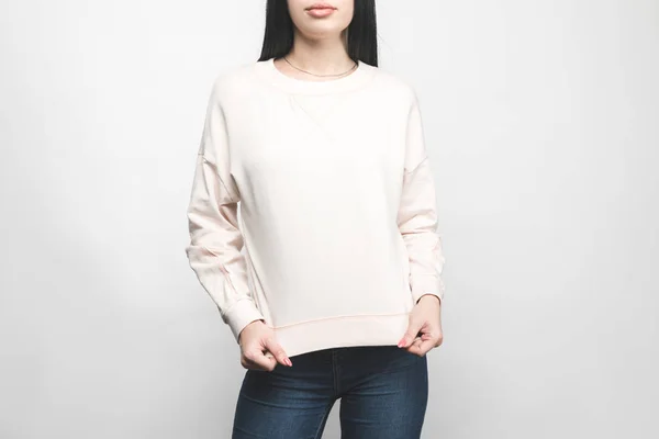 Cropped shot of young woman in blank sweatshirt on white — Stock Photo