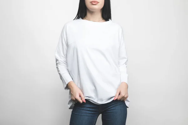 Cropped shot of young woman in blank sweatshirt on white — Stock Photo