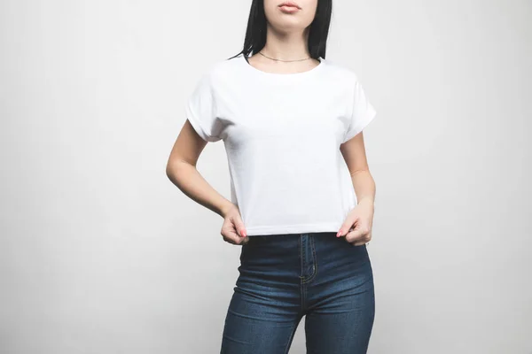 Attractive young woman in blank t-shirt on white — Stock Photo