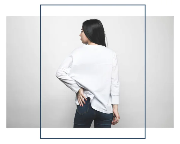 Rear view of attractive woman in blank sweatshirt on white with creative frame — Stock Photo