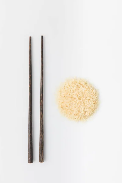 Tas de riz avec baguettes isolées sur blanc — Photo de stock