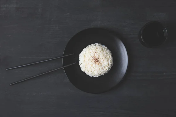 Top View Of Rice On Plate With Chopsticks On Black Table Water Tasty Stock Photo Top View Of Rice On Plate With Chopsticks On Black Table Water Tasty Stock Photo