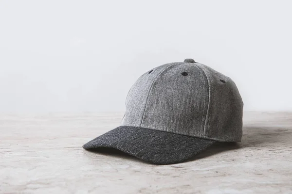 One grey cap on wooden table on white — Stock Photo
