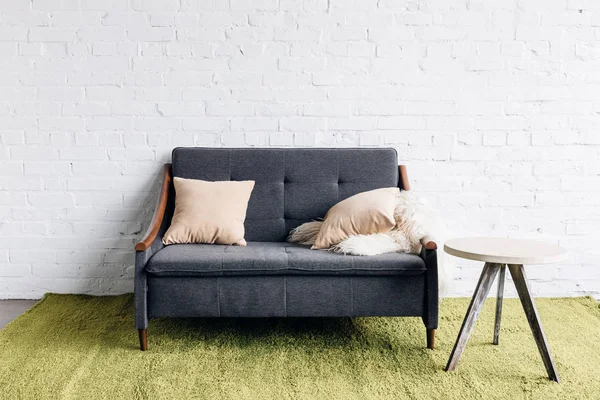 Small couch in modern living room with white brick wall, mockup concept — Stock Photo