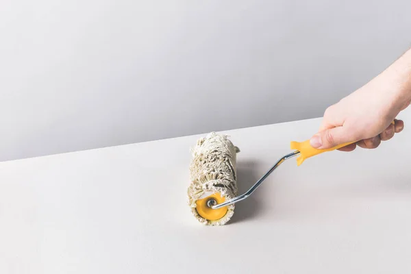 Cropped image of woman painting surface with paint roll brush — Stock Photo