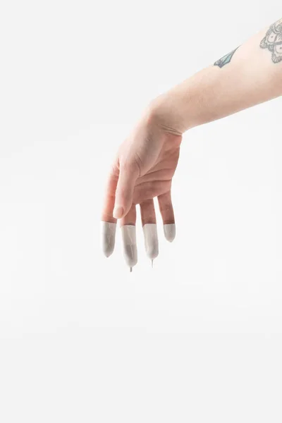 Cropped image of woman with fingers in white paint isolated on white — Stock Photo